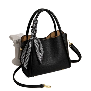 Elegant black lychee leather bucket bag with striped silk scarf handle and gold hardware