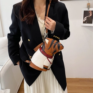 Fashionable animal-themed bucket bag in brown leather and white fleece on a model