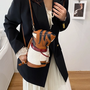 Puppy-shaped dachshund bucket bag in brown pebble leather and white faux fur trim