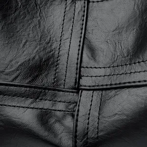 Detailed macro shot of premium black leather texture and reinforced double stitching design