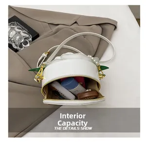 Detailed interior of the white floral round bag showing storage space for cosmetics