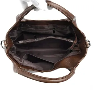 Interior view of soft leather tote bag showing large capacity with zipper compartments