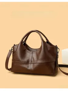 Close-up of brown soft leather handbag with stitching details and crossbody strap