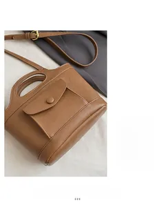 Detailed close-up of brown vintage leather handbag showing soft texture and fine stitching
