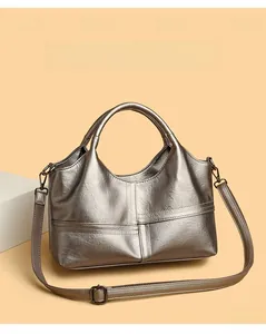 Detail of silver-grey pebbled leather handbag with sturdy handles and crossbody strap