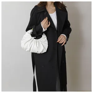 Detail showing the white pleated croissant bag texture and minimalist crescent design