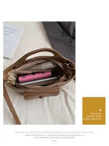 Interior view showing the large storage capacity of this brown leather bucket handbag