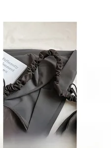 Detail shot of the wide pleated shoulder strap and smooth fabric of the hobo bag