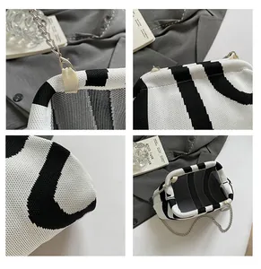 Close-up of black and white striped knit bag showing texture, chain link, and interior
