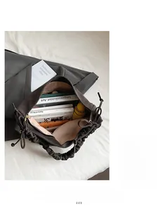 Top view of spacious interior of brown pleated tote bag filled with daily essentials