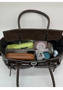 Detail view of large dark brown tote bag showing spacious interior with multiple pockets