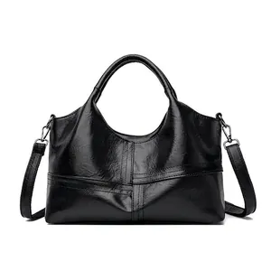 Large black polished faux leather tote bag with stylish stitched cross design