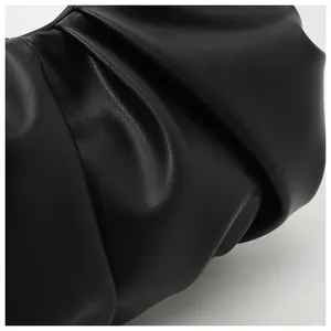 Detail shot of black ruched leather cloud bag showing soft pleated texture and matte finish