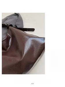 Detailed macro shot of vintage dark brown waxed leather texture on a tote bag surface