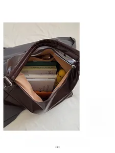 Spacious dark brown leather tote bag interior showing large capacity and silver zipper