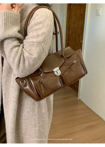 Detail showing the brown retro faux leather shoulder bag with silver metal lock closure