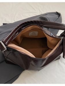 Hobo bag detail showing spacious interior with khaki fabric lining and metal zipper