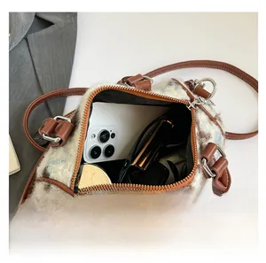 Interior view showing the capacity of this plush faux fur cow print Boston bag