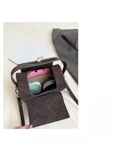 Interior view showing the large capacity of the vintage brown cylindrical shoulder bag