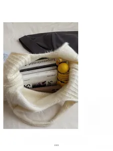 Detailed interior view of a white knitted tote bag showing its large storage capacity