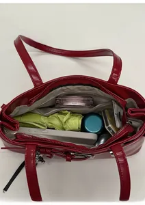 Top view of red shoulder bag interior showing large capacity with zipper pocket