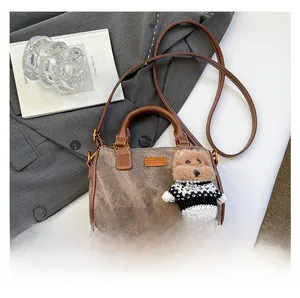 Detailansicht der Vintage-Boston-Tasche mit Marmortextur und süßem Teddybär-Anhänger