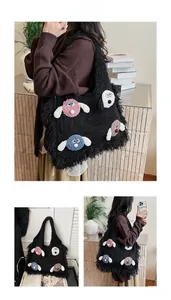 Detail of black faux fur tote bag with cute 3D cartoon puppies and fringe texture
