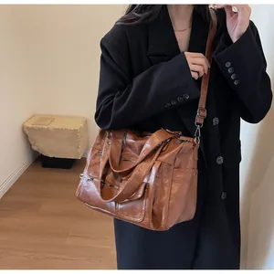 Retro brown large capacity tote bag with multiple zippers shown on model for commute