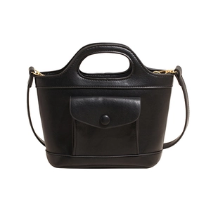 Classic black leather bucket bag with oval handle and gold hardware in minimalist design