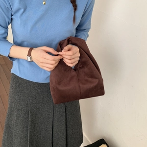 Fashionable dark brown suede handbag for women featuring a stylish twisted handle design