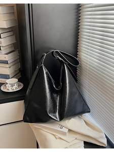 Detail of black oil wax leather texture on large capacity minimalist tote bag