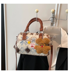 Detailed view of plush cow print Boston bag featuring Sweet Cherry patch and star charm