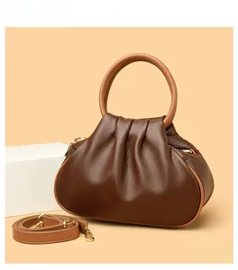 Close-up of deep brown lychee pattern cloud bag with round handle and metal hardware