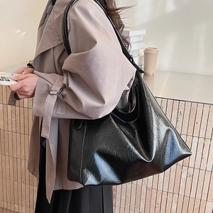 Minimalist black leather hobo tote bag for women with glossy textured finish for daily commute
