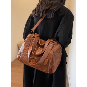 Vintage brown large capacity shoulder bag for women with multi-pocket design on model