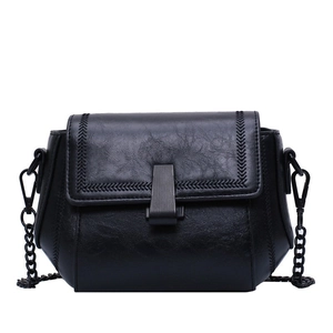 Classic black leather crossbody flap bag with chevron stitching and a dark metal chain strap
