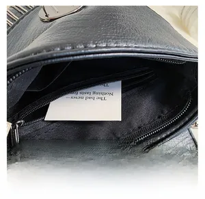 Detail shot of the black PU leather handbag showing the secure interior zipper pocket