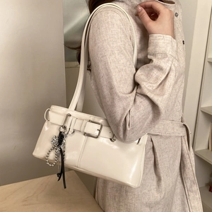 Minimalist white baguette shoulder bag with metal buckle and bow charm detail