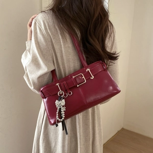 Chic burgundy faux leather underarm bag with silver buckle and bow charm detail