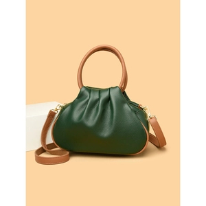 Dark green leather dumpling bag with brown handles and elegant pleats on beige background