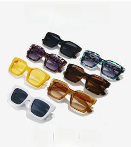 Multiple stylish polygon sunglasses in various colors and floral patterns on white background