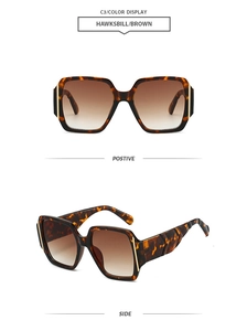 Detail view of tortoiseshell square sunglasses with brown gradient lenses and gold temple accents