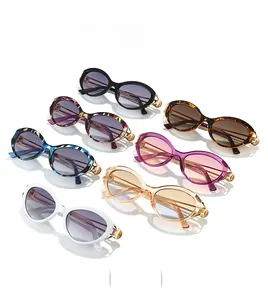 Flat lay of retro oval sunglasses in seven trendy colors with gold metal temple accents