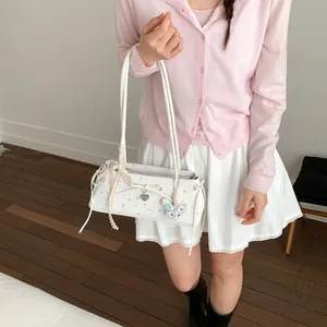 Détail du sac sous l'aisselle à fleurs avec nœud en dentelle et pendentif lapin
