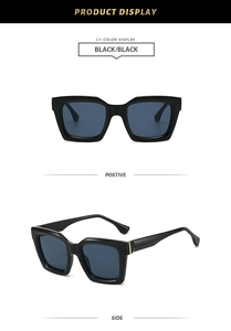 Detail view of stylish polygon sunglasses with thick black frames and dark lenses