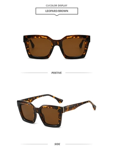 Detail of leopard print tortoiseshell sunglasses with brown lenses and gold metal hinges