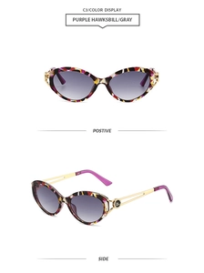 Detail view of purple tortoise cat-eye sunglasses with gray gradient lenses and gold hinges