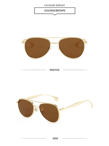 Détail de lunettes de soleil aviateur en métal doré avec double pont et verres bruns