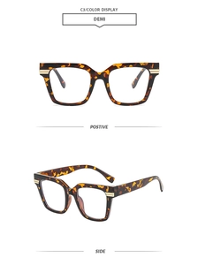 Detail of demi tortoise shell oversized square glasses frame with elegant metal accents