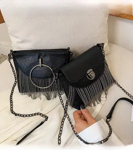 Detail of black PU leather bags with metallic tassels and gunmetal chain straps